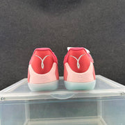 Rear view of the pink and white shoes showing Kobe-related heel graphics and translucent outsoles.