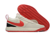 Cream low-top Nike Book 1 shoe with red Swoosh and red outsole