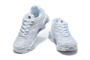 Front and top views of a pair of white Nike Shox Ride 2 sneakers.
