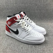 Pair of white, red, and black mid-top sneakers shown from a front three-quarter angle.