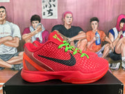 Side profile of a red Nike basketball sneaker showing the textured upper, black Swoosh, green laces, and translucent heel detail.