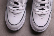 Close-up of the perforated white toe boxes with black accent piping