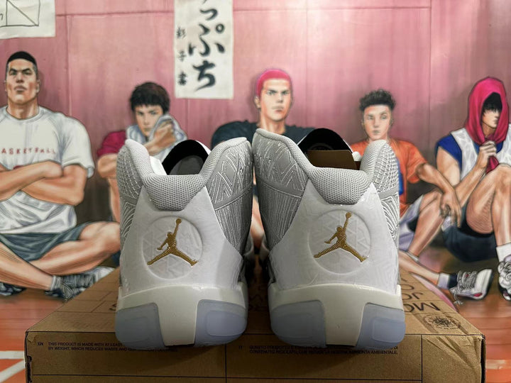Rear view of white and silver Jordan basketball shoes with gold-tone heel logos