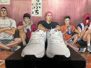 Front view of white Nike basketball shoes with black outsole accents