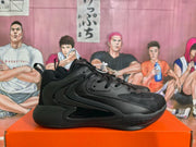 Side view of a black Nike basketball sneaker showing the layered upper, padded collar, side branding, and rubber outsole.