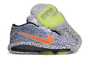 Side view of blue-patterned Nike GT Hustle 3 with orange accents and lime outsole details.