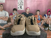 Front view of beige and cream basketball sneakers showing laces, perforated toe panels, padded tongues, and contrasting outsole sections.