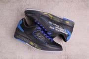 Overhead view of the pair showing the black uppers, blue details, side graphics, and translucent outsole sections.