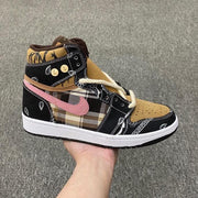 Side profile of one mid-top sneaker with black paisley panels, brown plaid sections, pink accent, and white midsole.