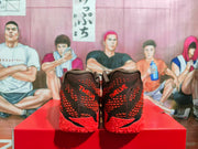Rear view of the red and black sneakers showing the textured heels and “TWELVE” lettering.