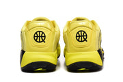 Rear view of the yellow sneakers showing padded heel panels, black circular heel logos, and black outsole sections.