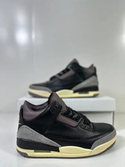 Close angled view of the black sneaker with perforated panels, gray overlays, and cream midsole accents.
