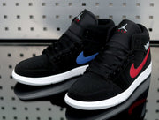 Pair of black Jordan high-top sneakers with blue and red side accents, white midsoles and gray outsoles.