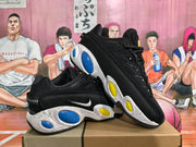Pair of black sneakers displayed at an angle, showing the side Swoosh, textured upper, and contrasting blue and yellow midsole accents.