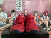 Front view showing the red lace-up design, padded tongues, and dark toe outsoles marked with the number 20.