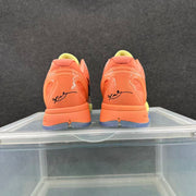 Rear view of the orange heels showing molded heel details, black signature-style markings, and blue outsole sections.