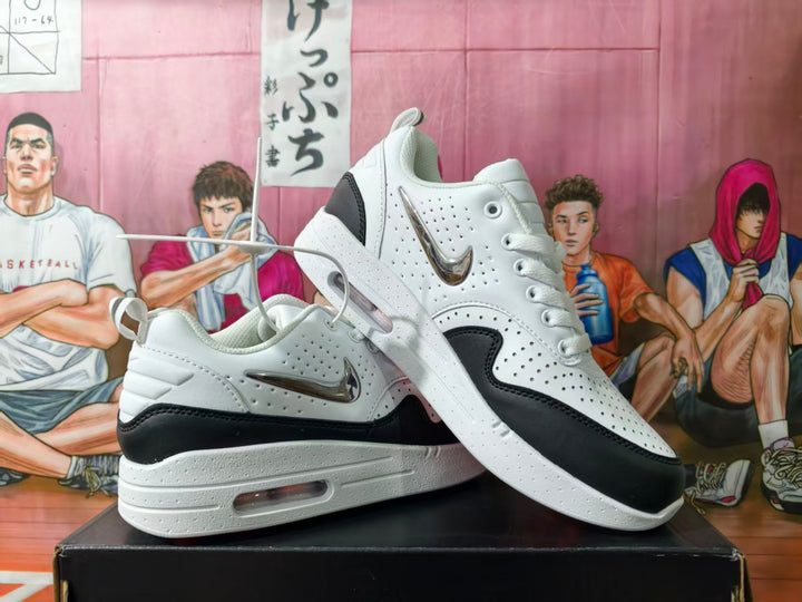 White and black low-top Nike sneakers shown from the side, with perforated panels and a visible midsole cushioning unit.