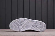 Close-up of the white rubber outsole with circular forefoot and segmented tread patterns.