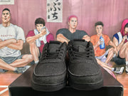 Front view of black Nike sneakers with lace-up closures, stitched panels and dark rubber soles.