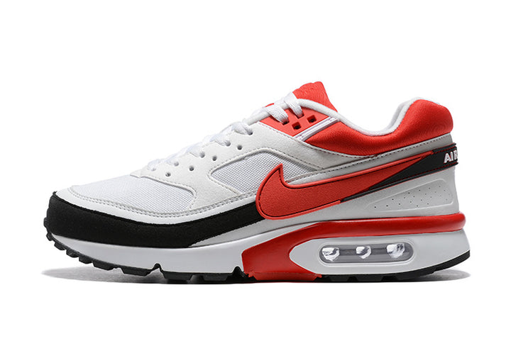 Side view of a white Nike Air Max BW sneaker with red accents, a black mudguard, and a visible heel air unit.