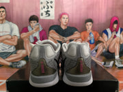 Rear view of gray and pink Nike sneakers showing padded collars, heel panels, and layered soles.