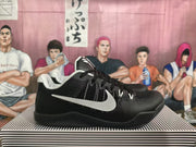 Side view of a black basketball shoe with a white Nike Swoosh.