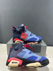 Close angled view highlighting the side panels, perforations, laces, and attached red accessory tag.