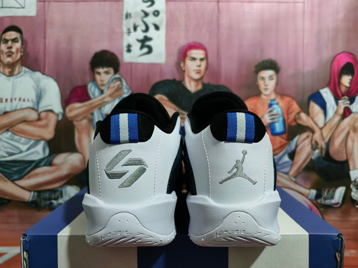 Rear view of black, white, and blue Jordan basketball shoes with contrasting heel details.