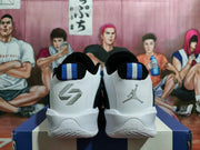 Rear view of black, white, and blue Jordan basketball shoes with contrasting heel details.