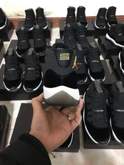 Rear view of the sneaker showing the heel branding, black upper, white midsole, and translucent heel outsole.