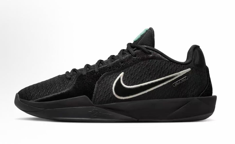 Black Nike low-top basketball sneaker with a white Swoosh and sculpted black outsole.