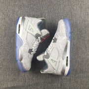 Pair of Jordan Air Jordan 4 sneakers displayed from the side, highlighting the graphic upper and translucent blue soles.