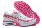 Side view of white and pink Nike Air Max BW-style sneakers, including the pink tread and visible heel cushioning window.