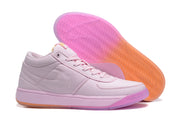 Pink sneakers displayed with one shoe angled to show the translucent patterned outsole.