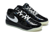 Angled pair view highlighting the black glossy uppers, white laces, white side branding, and light-colored outsoles.