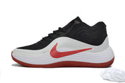 Side profile of a black, white, and red Nike basketball sneaker.