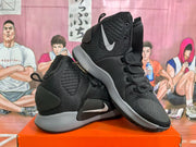 Angled side view of black Nike basketball sneakers with contrasting Swoosh branding, lace-up closure and grey midsoles.