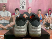 Rear view showing the black heel panels, pull tabs, orange lining, and patterned heel sections.