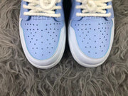 Close view of the perforated mist blue toe panels, white toe trim, and plush light-colored laces.