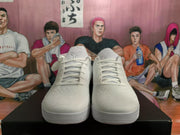 Front view of white Nike basketball sneakers with lace-up closures, textured uppers, and layered soles.