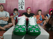 Front view showing the green patterned uppers, white laces, red accents, and green toe outsoles.