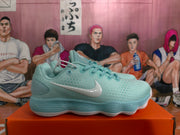 Side profile of a mint green Nike sneaker showing the contrasting Swoosh, textured upper and ribbed sole.
