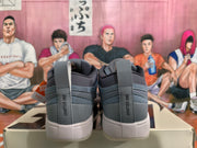 Rear view of smoke gray low-top sneakers showing Chapter One heel lettering, padded collars and light-colored textured soles.