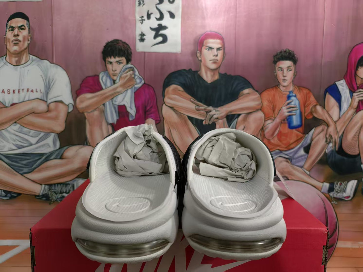 Pair of white and black Nike sneakers viewed from the front, showing padded collars and visible air cushioning units.