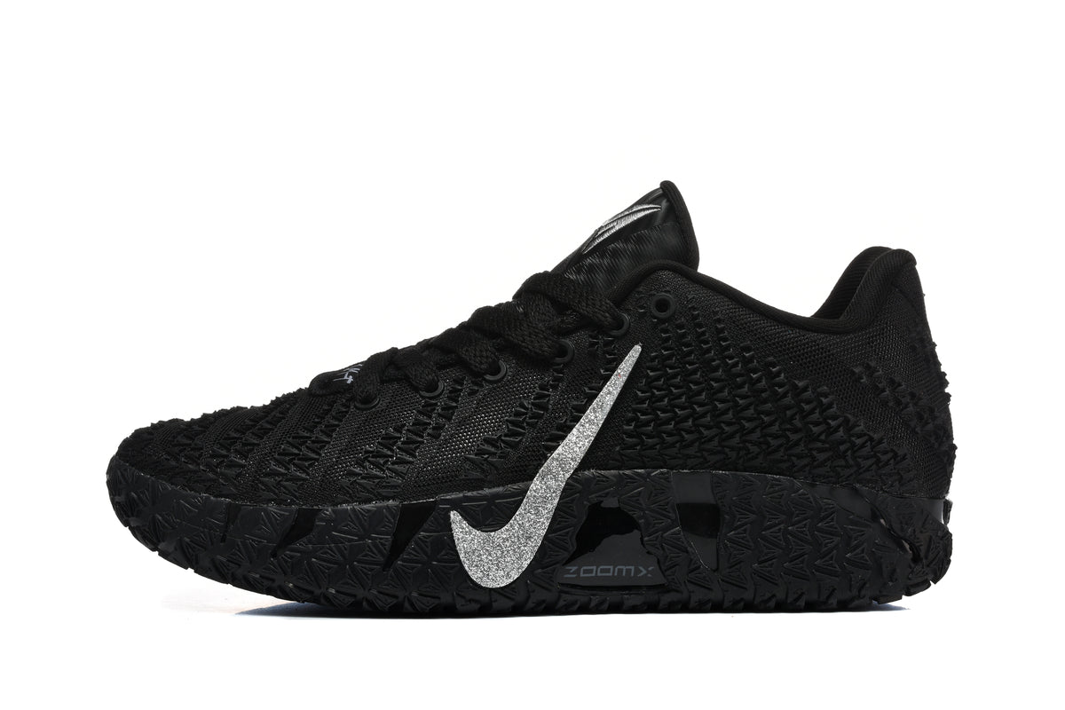 Side view of a black low-top sneaker with a silver swoosh, textured upper, and patterned sole.