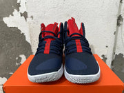 Front view showing navy textured uppers, red tongues and white outsoles