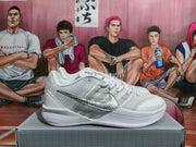 White and silver Nike Kobe basketball shoe shown from the side