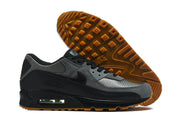 Nike Air Max 90 sneaker beside a view of its gum-colored tread outsole