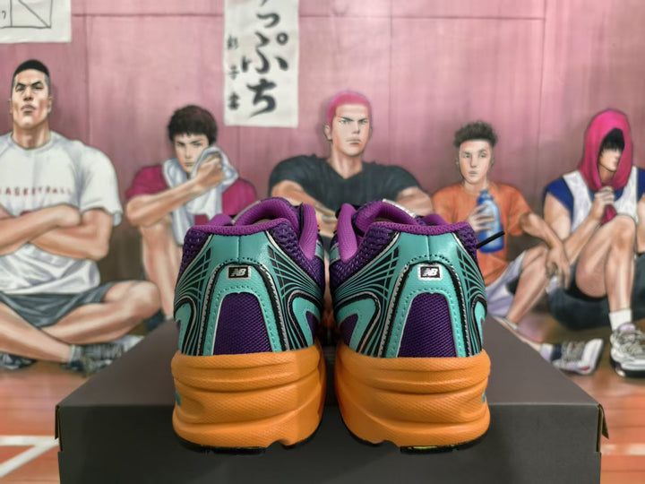 Rear view of purple and teal New Balance sneakers with orange midsoles and multicolor accents on a black box