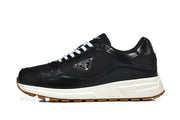 Side view of a black low-top lace-up sneaker with a triangular side plaque, off-white midsole, and gum-colored outsole.